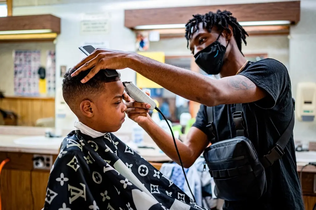 Barber giving a young client a haircut