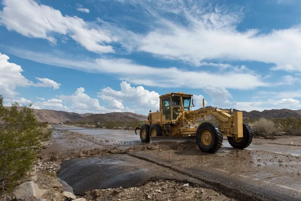 Debris: Excavator removing debris road flooding