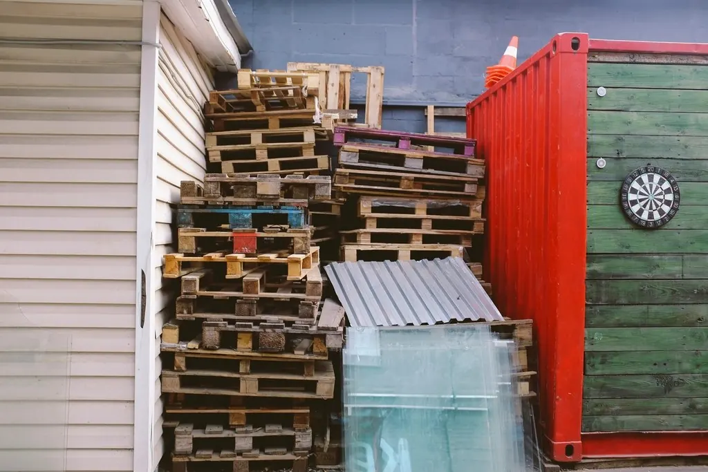 Debris: Pallets stacked corrugated steel garbage