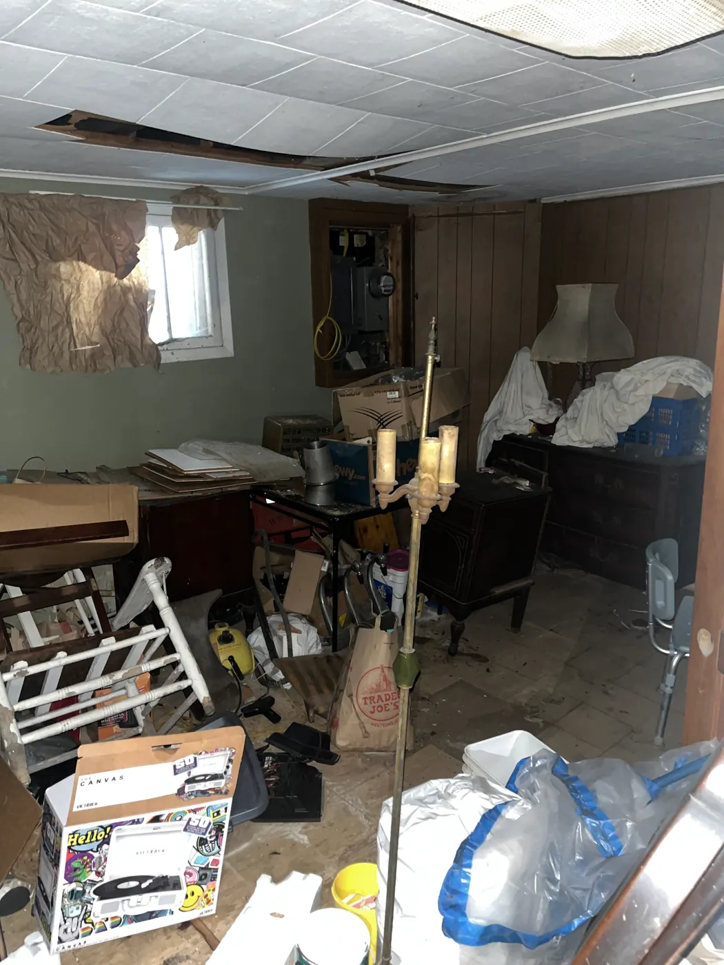 Cluttered room with furniture and boxes before removal