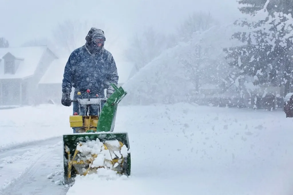 Person clearing snow with a snow blower